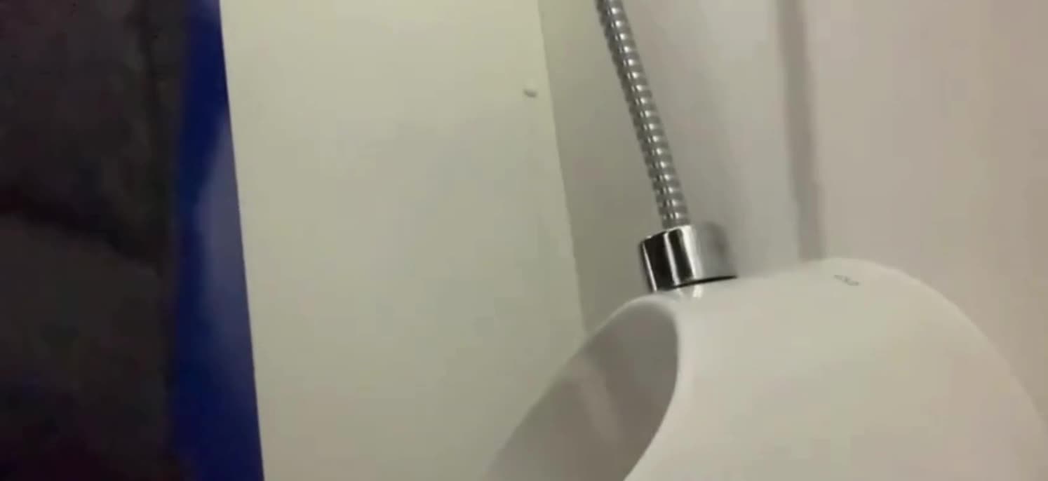 Boy enjoying his penis while peeing